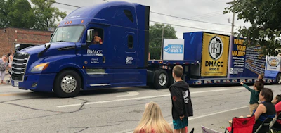 DMCAA President Rob Denson drives the school’s Freightliner ina parade (DMCAA photo)