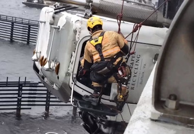 Chesapeake firefighter Justin Beazley rescues Wayne Boone, of Suffolk, Virginia, whose truck went off the High Rise Bridge in Virginia.