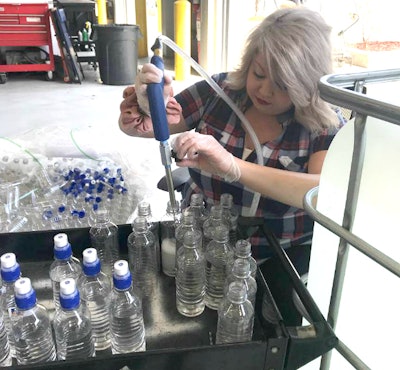 Emily Smith fills bottles with hand sanitizer for Prime drivers. She normally works at Prime’s Oasis Hotel and Convention Center. (Prime photo)