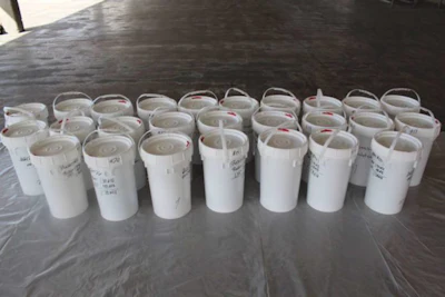 Buckets filled with liquid meth drained from a truck’s fuel tanks