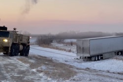 National Guard troops used heavy equipment to rescue tractor-trailers that had trouble in the winter weather conditions in Oklahoma Monday.