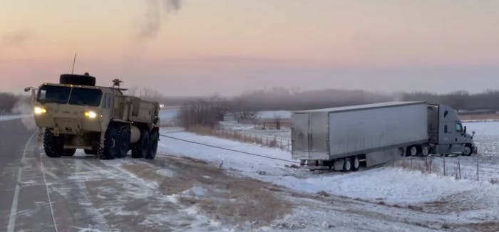 National Guard troops used heavy equipment to rescue tractor-trailers that had trouble in the winter weather conditions in Oklahoma Monday.
