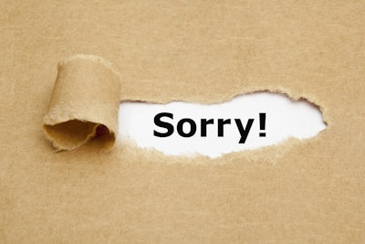 The,Word,Sorry,Appearing,Behind,Torn,Brown,Paper.