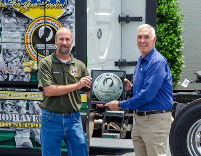 Darrell Plonk (left) Llogistics manager at Daimler Trucks’ Cleveland, North Carolina Freightliner plant, delivers the Ride of Pride tractor to Jim Raynor, Old Dominion Freight Line’s vice president of maintenance and equipment.