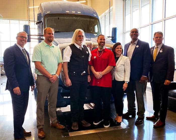 From left are Brad Bentley, FASTPORT president; Joey Mendel, general manager of the MHC RoadReady Center in Chillicothe, Ohio; Jimmy Reddell/U.S. Army, Army Reserves/Stevens Transport; Christopher Slindee/U.S. Army/Knight Transportation; Genevieve Bekkerus, Kenworth marketing director; James Rose/U.S. Marines/PRIME Inc.; and Adam Rocke, senior director of outreach and engagement for Hiring Our Heroes.
