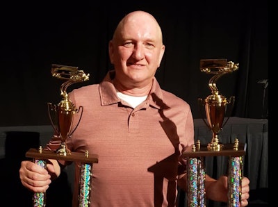 Man with trophies