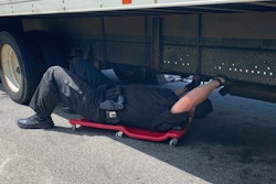 Police officer inspecting a truck