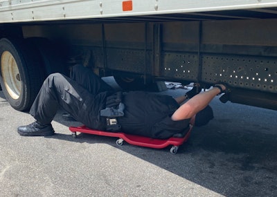 Police officer inspecting a truck