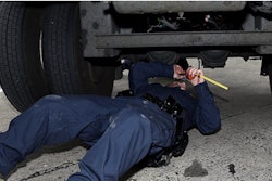Inspector checks truck's brakes