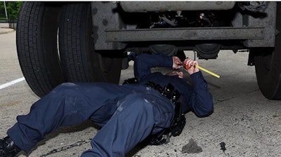 Inspector checks truck's brakes