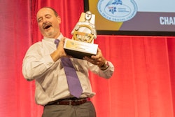 Truck driver with championship trophy
