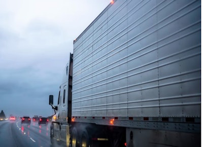 Tractor-trailer on highway in rain