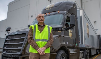 Truck driver standing in front of UPS tractor-trailer