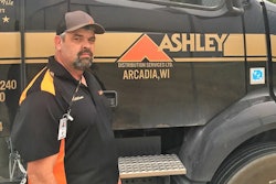 Man standing ion front of tractor-trailer