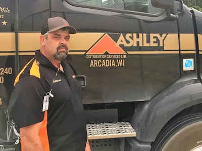 Man standing ion front of tractor-trailer