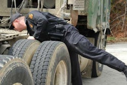 Officer inspecting big rig
