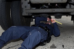 Inspector under truck