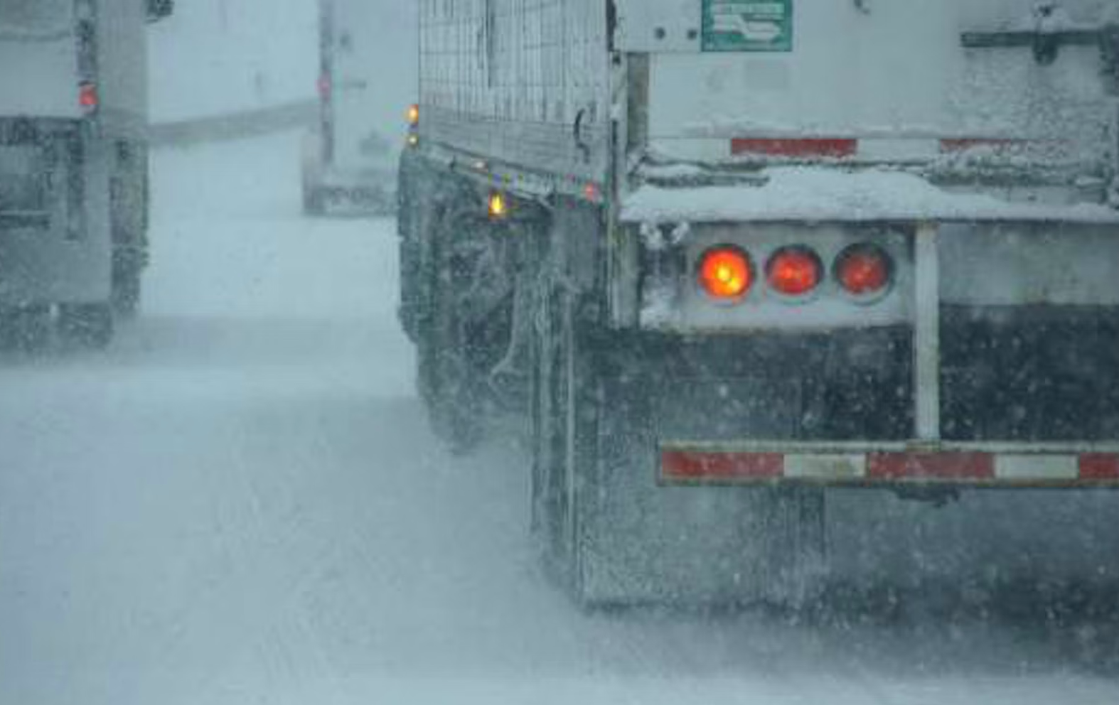 Trucks on snow-covered highway
