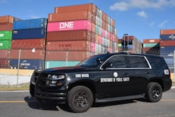 Police car in front of shipping containers
