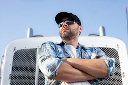 Truck driver in front of his truck