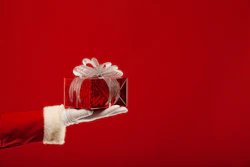 Santa handing a Christmas gift