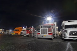 Big rigs in parking lot at night