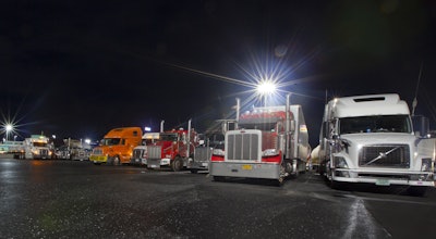 Big rigs in parking lot at night