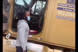 Truck driver next to tractor-trailer