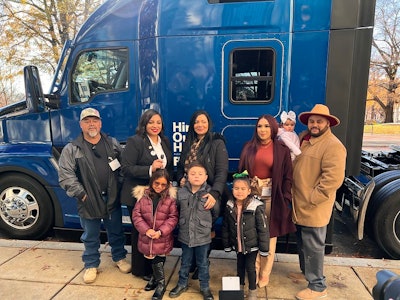 Contest winner and her family with the truck she won