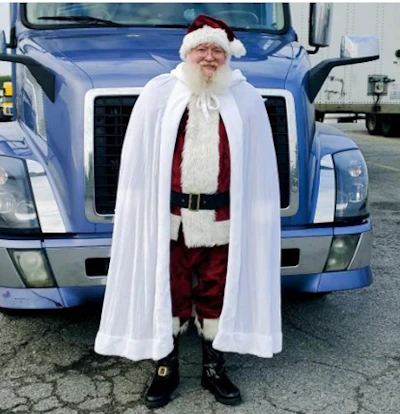 Santa in front of his truck