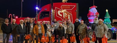 People in front of semi truck