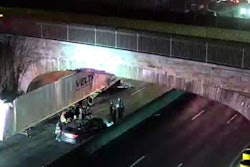 Traffic cam photo of trailer stuck under an overpass