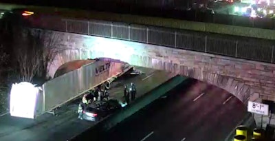 Traffic cam photo of trailer stuck under an overpass