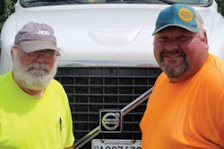 Two truck driver in front of truck