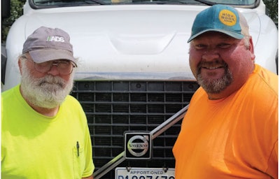 Two truck driver in front of truck