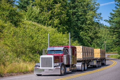 Tractor-trailer on the highway with load of lumber