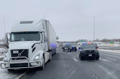 tractor-trailer stopped on I-70 with police cars