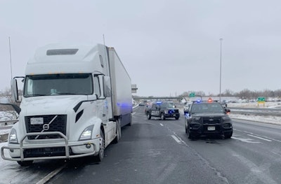 tractor-trailer stopped on I-70 with police cars