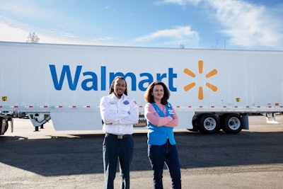 Man and woman in front of a Walmart trailer