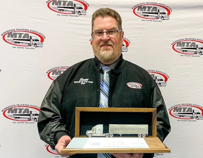 Scott Swenson holding Driver of the Year trophy