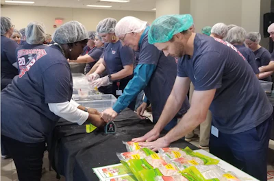 Southeastern Freight Lines employees package meals for Harvest Hope Food Bank.