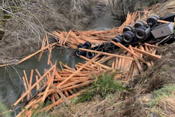 Truck crash with spilled load of lumber