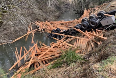 Truck crash with spilled load of lumber