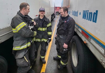 Firefighters with cat found on tractor-trailer