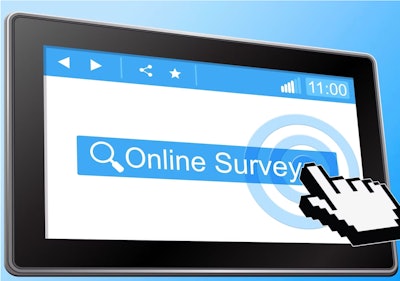 Hand touching 'online survey' on computer screen