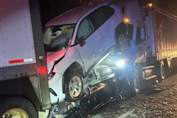 Two cars crashed between 2 tractor-trailers