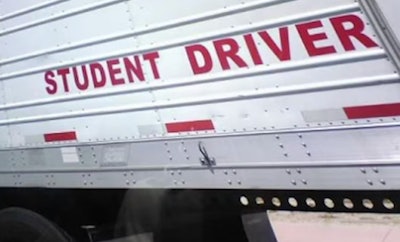 'Student Driver' sign on side of trailer