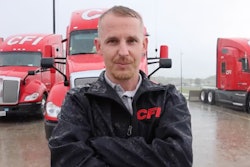 Truck driver Zach Yeakley in front of several truicks