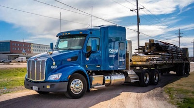 Blue flatbed tractor-trailer