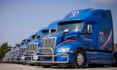 Line of blue Peterbilt trucks